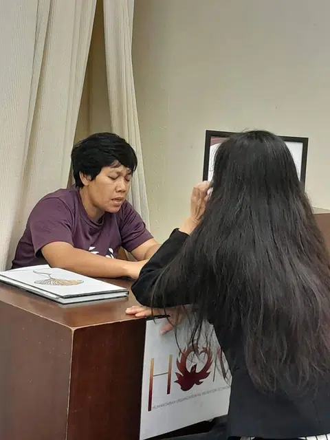 Ms Istriyanti (left), a domestic worker, spends every other Sunday at Home's help desk for Indonesian domestic workers in City Plaza.