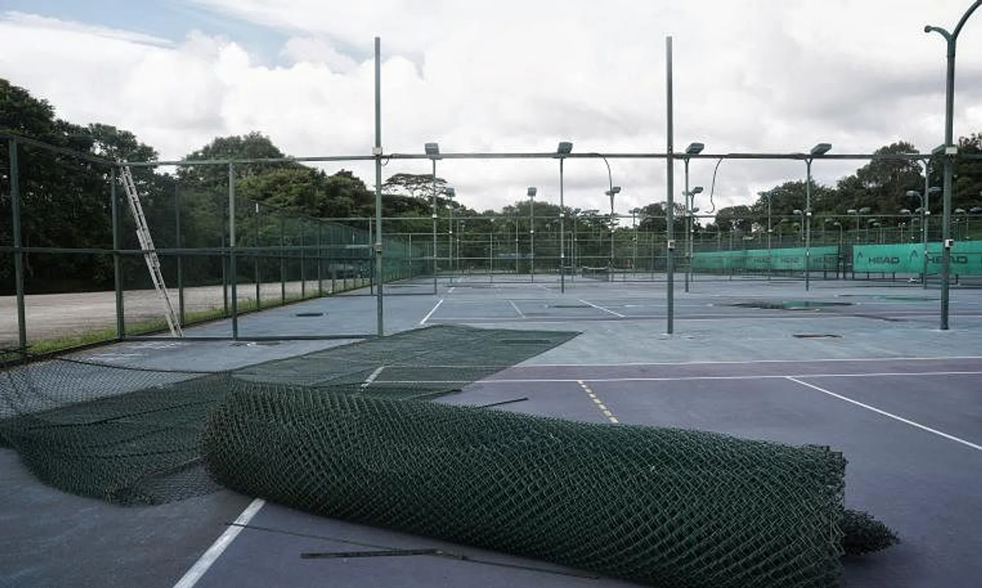 The tennis courts, some of which have had their nets and fences taken down, at The Cage Sports Park on Dec 21.