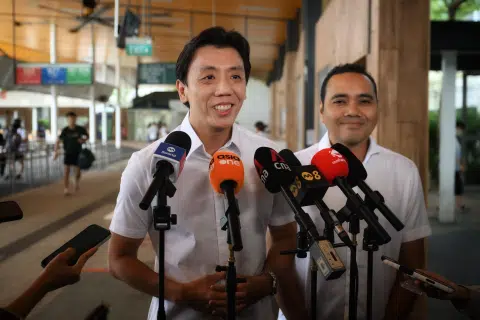Acting Transport Minister Jeffrey Siow (left) and Chua Chu Kang GRC MP Zhulkarnain Abdul Rahim speaking to the media at Choa Chu Kang bus interchange on Oct 12.