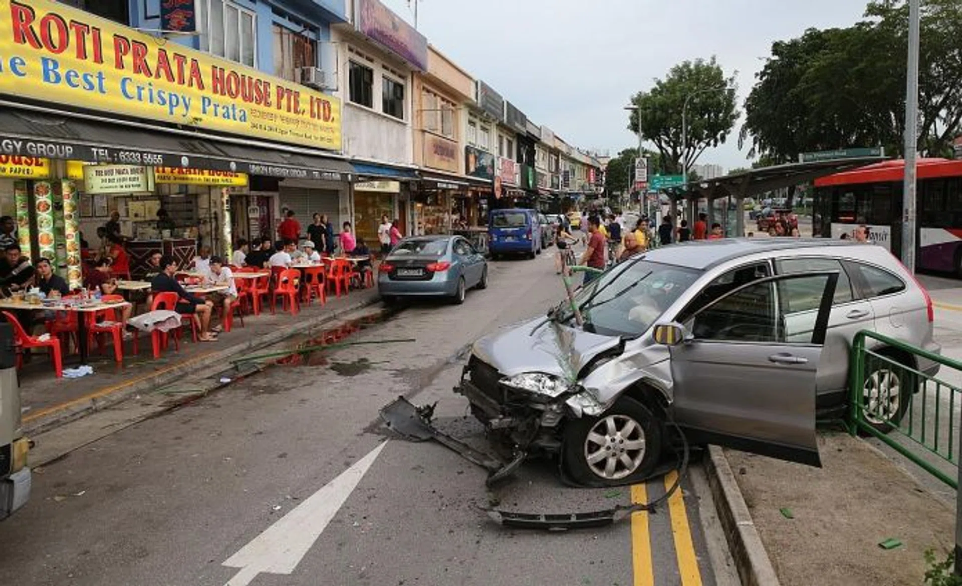 AFTERMATH: A car hit the railing near the Roti Prata House at Upper Thomson Road last Sunday. Parts of the railing landed close to customers sitting outside the eatery, raising questions about the potential danger of these projectiles.