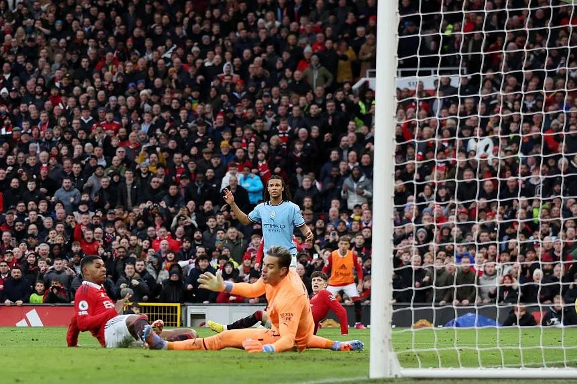 Manchester United's Marcus Rashford (left) scoring their second goal past Manchester City's Ederson. 
