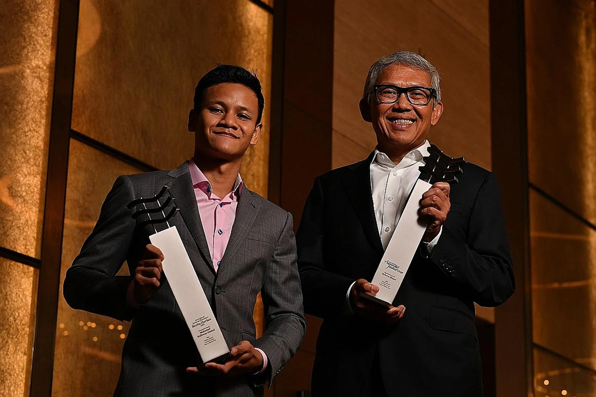 (From left) Muhamad Ridhwan and Bahren Shaari with their trophies. 