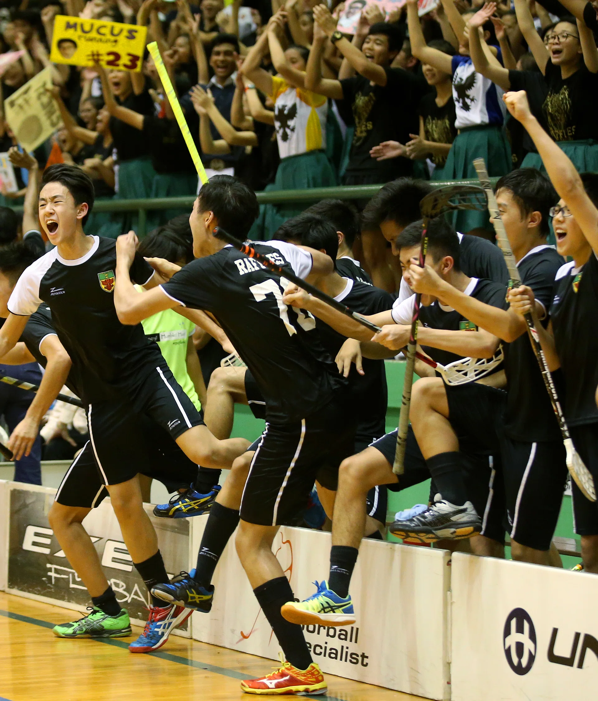 TEAM EFFORT: The Raffles Institution players celebrating at the final whistle. 