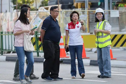 MP for Mountbatten SMC Gho Sze Kee (second from right) interacting with LTA and PUB staffs at the site of the sinkhole along Tanjong Katong South road at 8.56am on July 27.