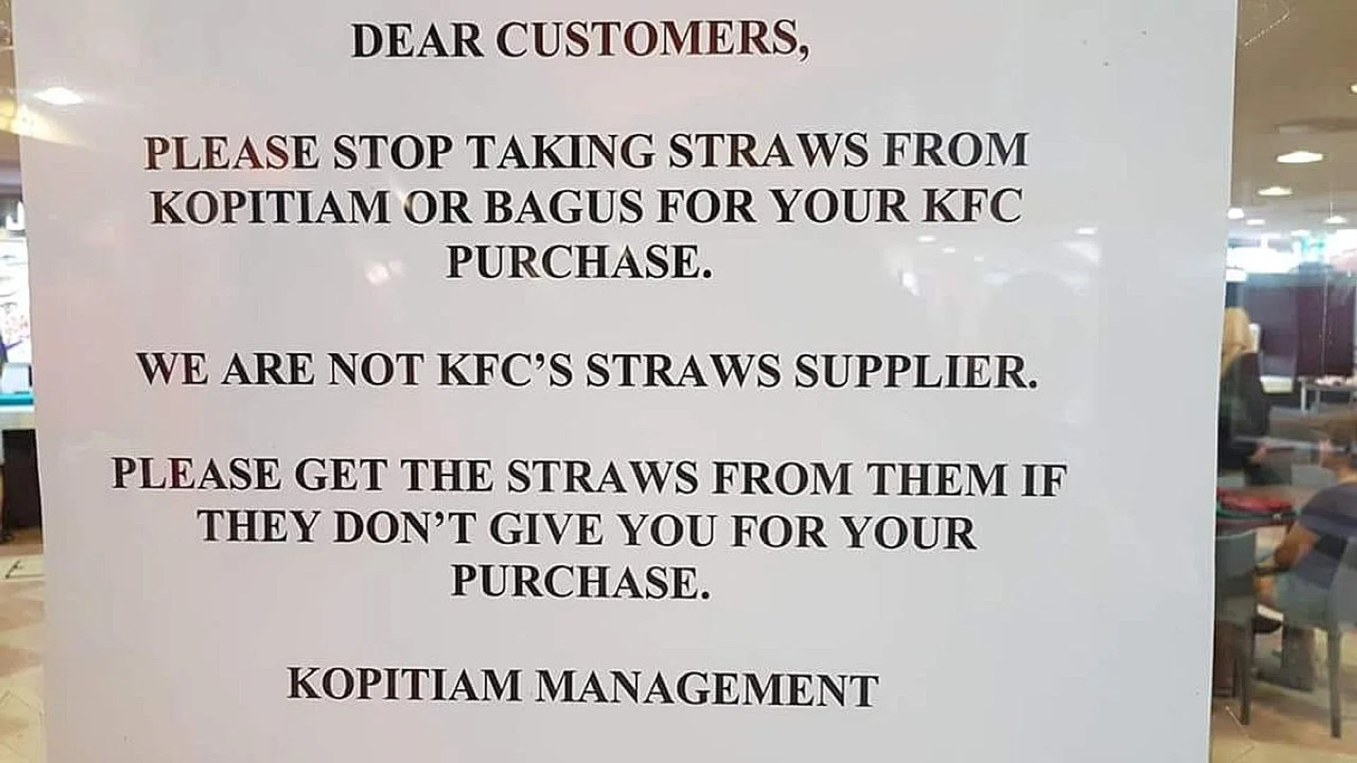 The sign telling KFC customers to stop taking the foodcourts' straws. 