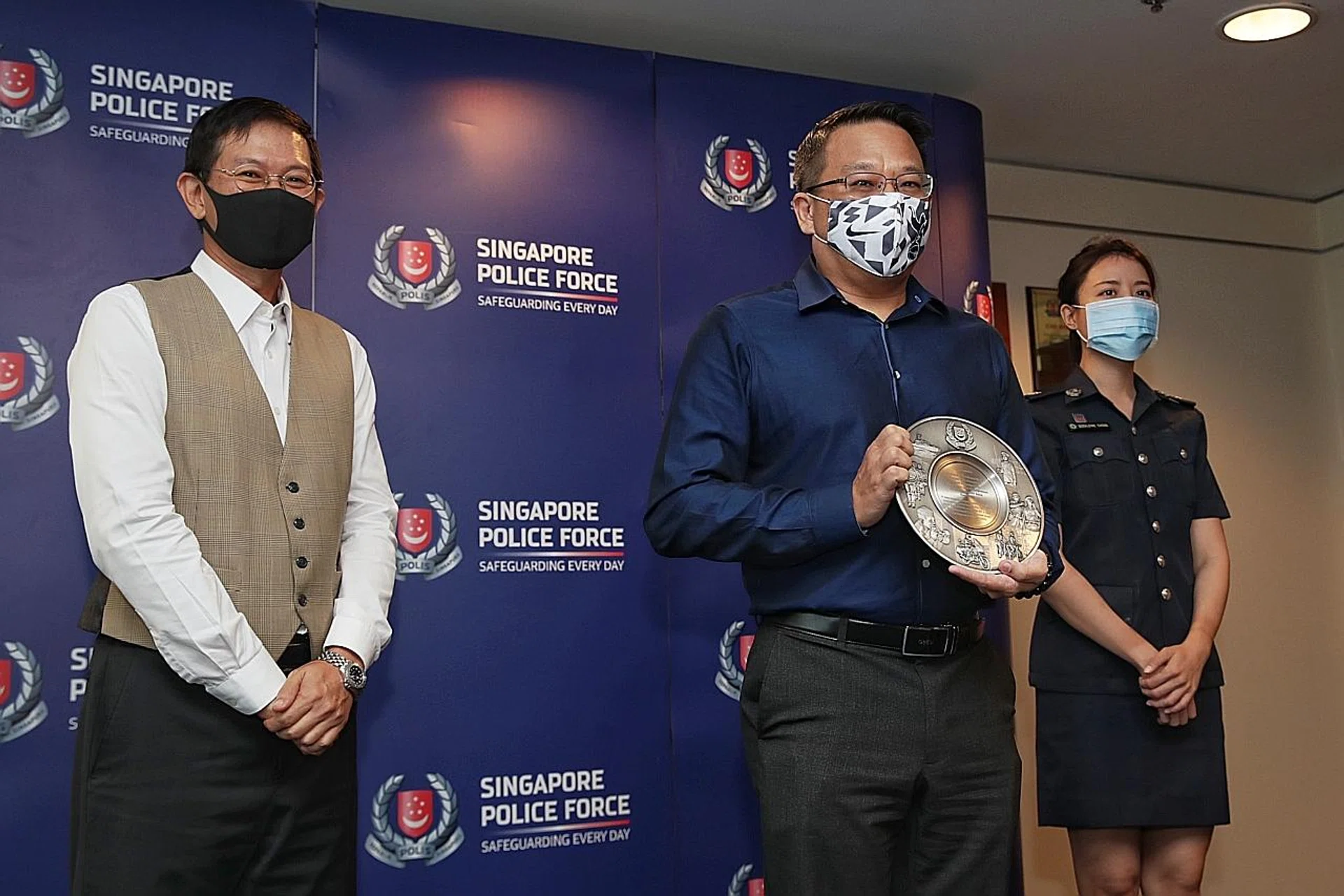 (From left) Commercial Affairs Department director David Chew, head of investigations at UOB's integrated fraud management department Richard Soh and Assistant Superintendent of Police Geraldine Cheng at an award presentation. 