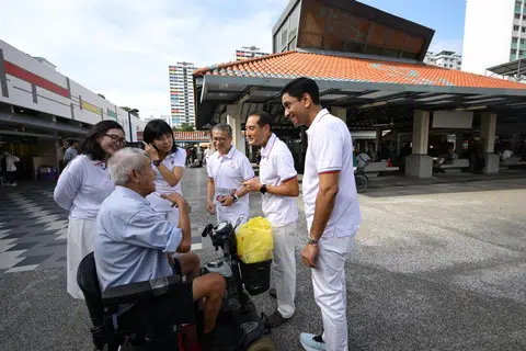 PAP's East Coast GRC candidates (from left) Hazlina Abdul Halim, Jessica Tan, Edwin Tong, Tan Kiat How and Dinesh Vasu Dash meeting a resident during a walkabout at The Marketplace @ 58 in New Upper Changi Road on April 24.