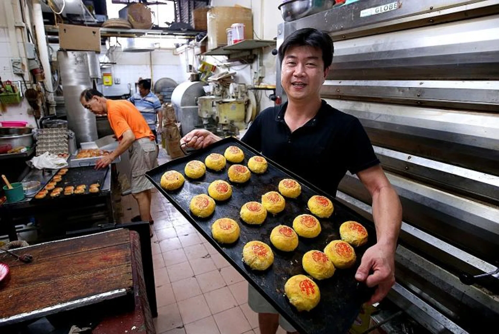 TRADITIONAL TREAT: Mr Lawrence Lim, the second-generation owner of Gin Thye Cake Maker, is one of a few in Singapore that make traditional Teochew pastries and cakes.
