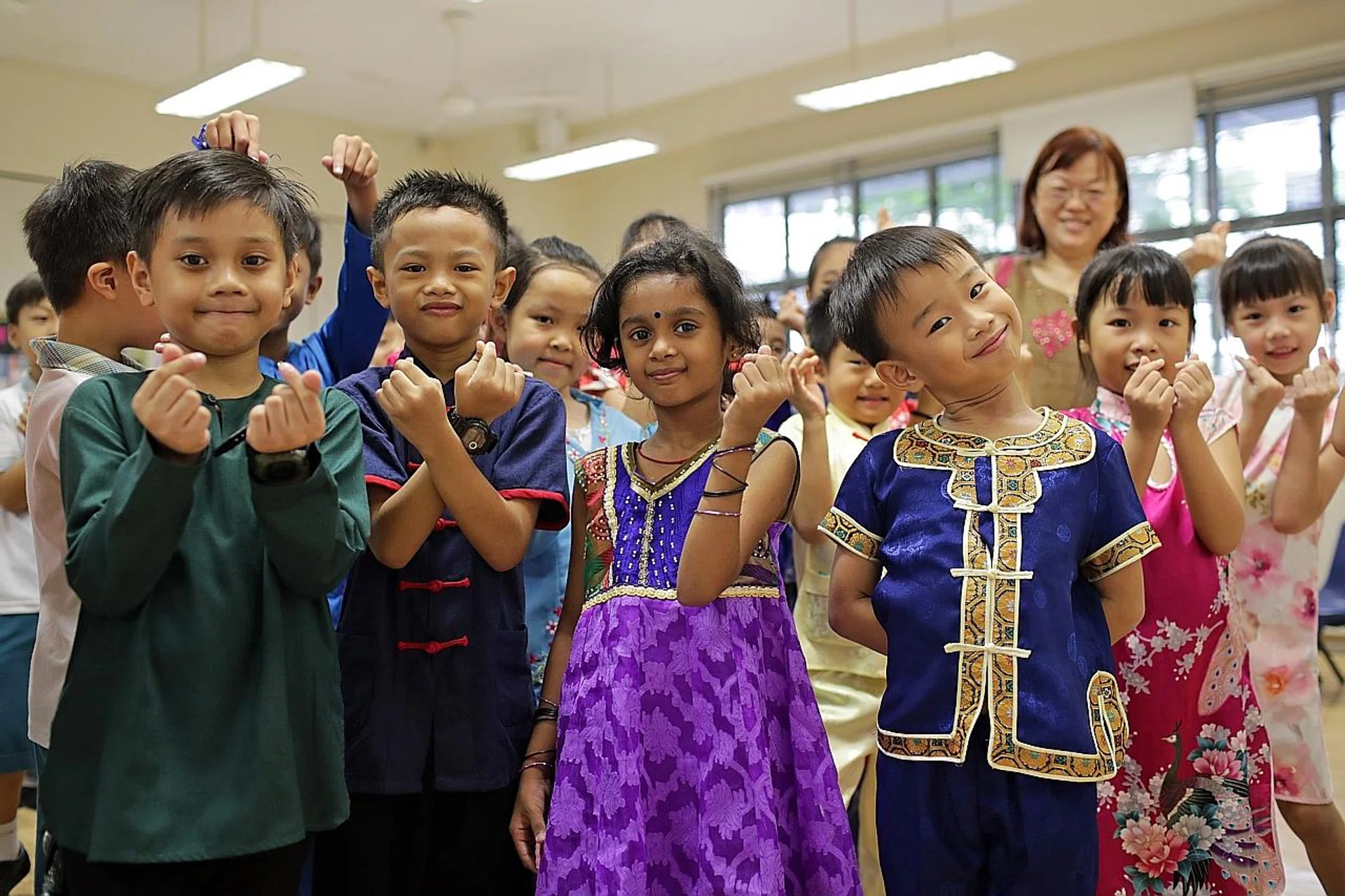 Pupils celebrating Racial Harmony Day. Mr Edwin Tong said young people are perhaps getting closer to the ideal state of unity and harmony than the older generation. 