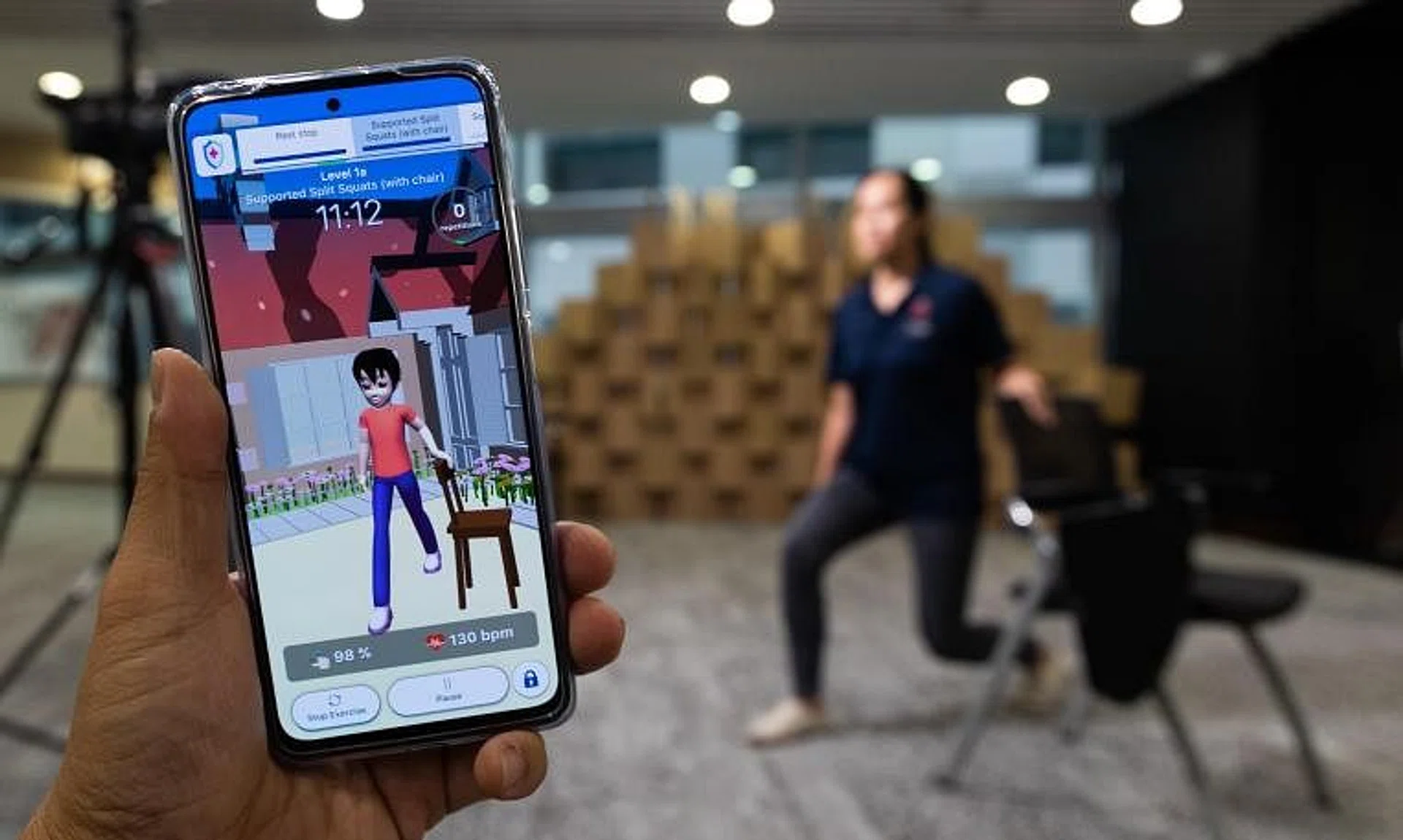 Senior physiotherapist Ms Cheryl Heng demonstrates a stretching exercise with the app MoveVid that helps patients with long Covid.