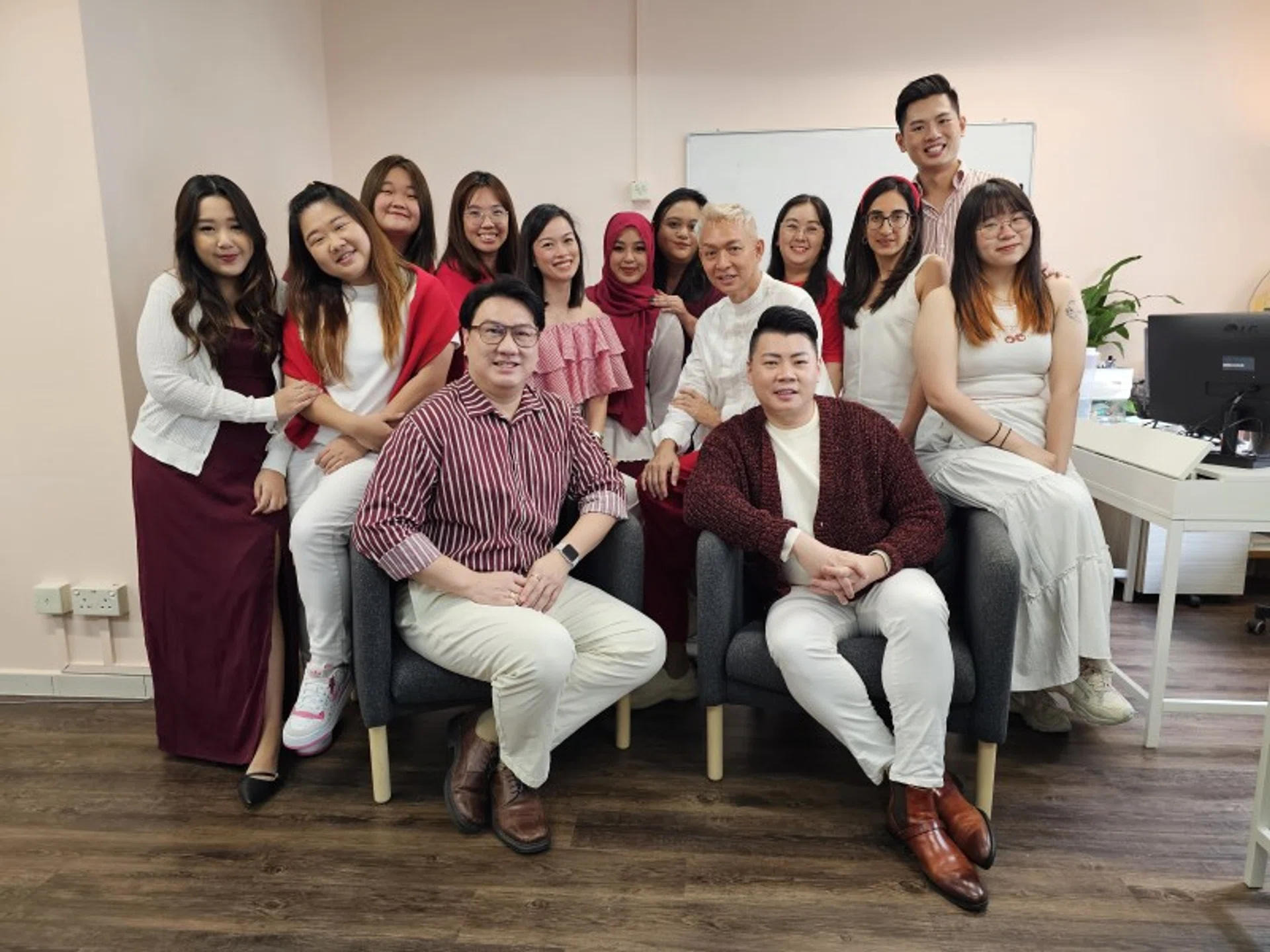 Mr Jansen Siak (wearing a striped shirt) and his Word of Mouth Communications and Insider Communications teams.