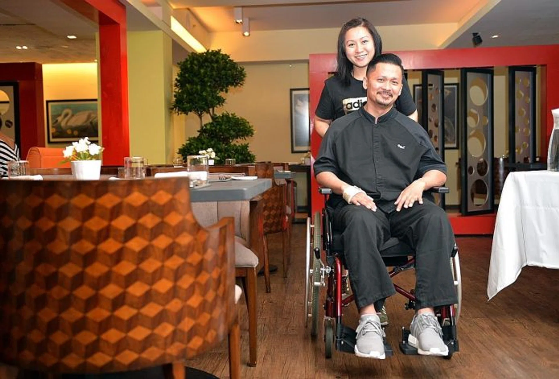 STAYING POSITIVE: Mr Muhammad Haikal Johari with his wife, Madam Rafiqah Soh.