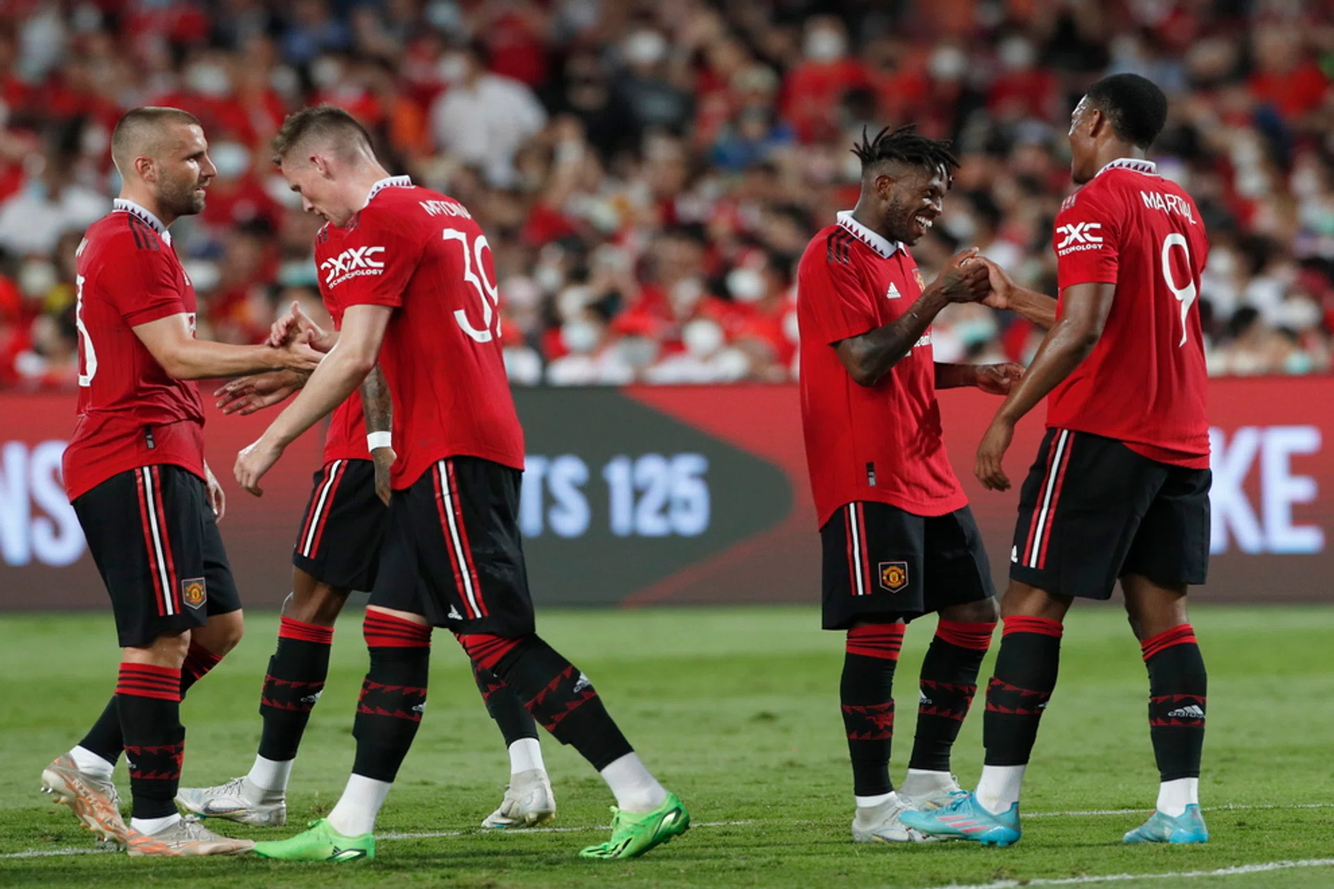 Manchester United's Fred (17) celebrates with teammates after scoring their second goal against Liverpool. 
