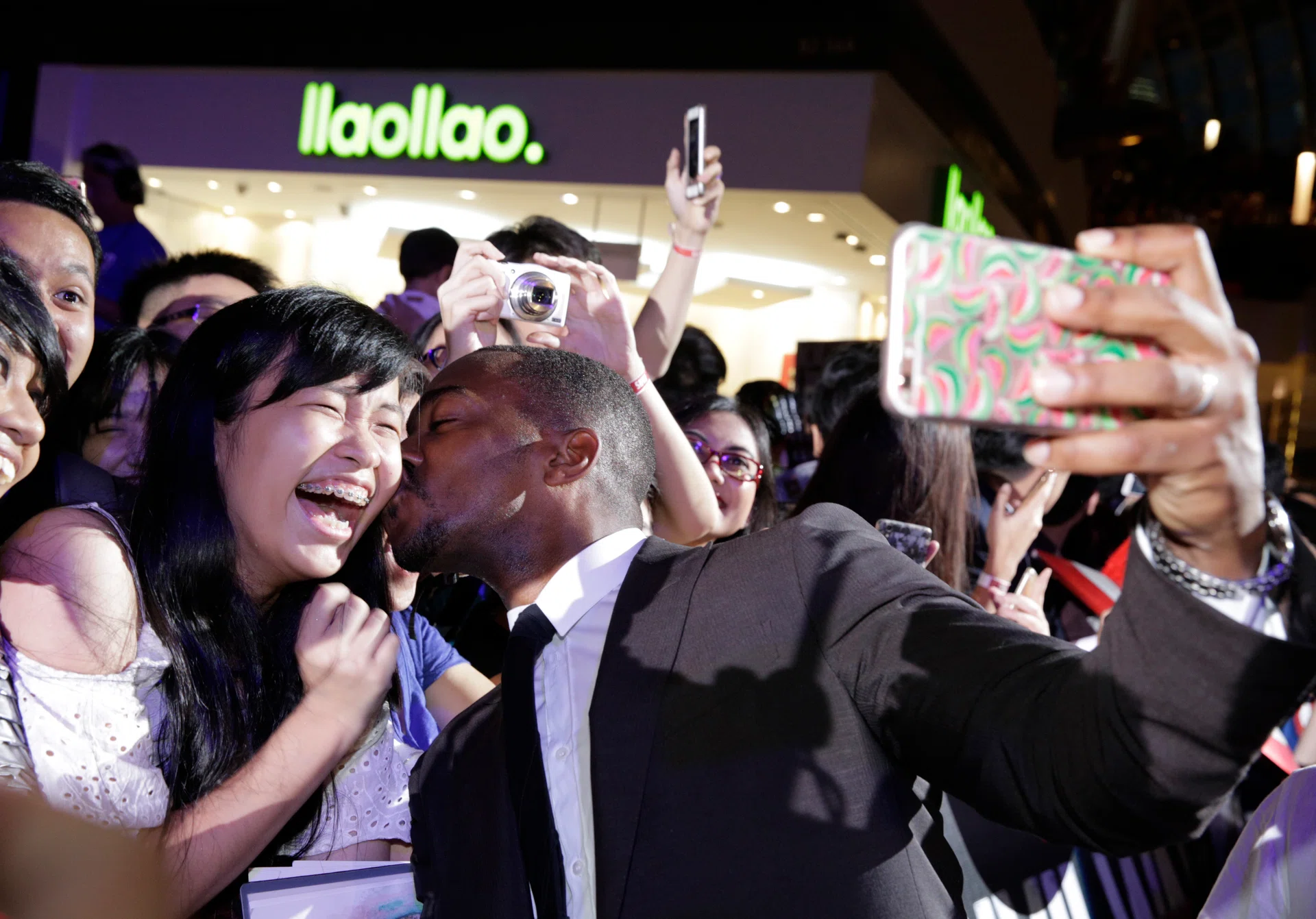 FAN FAVOURITE: Mackie getting cosy with a jubilant fan.