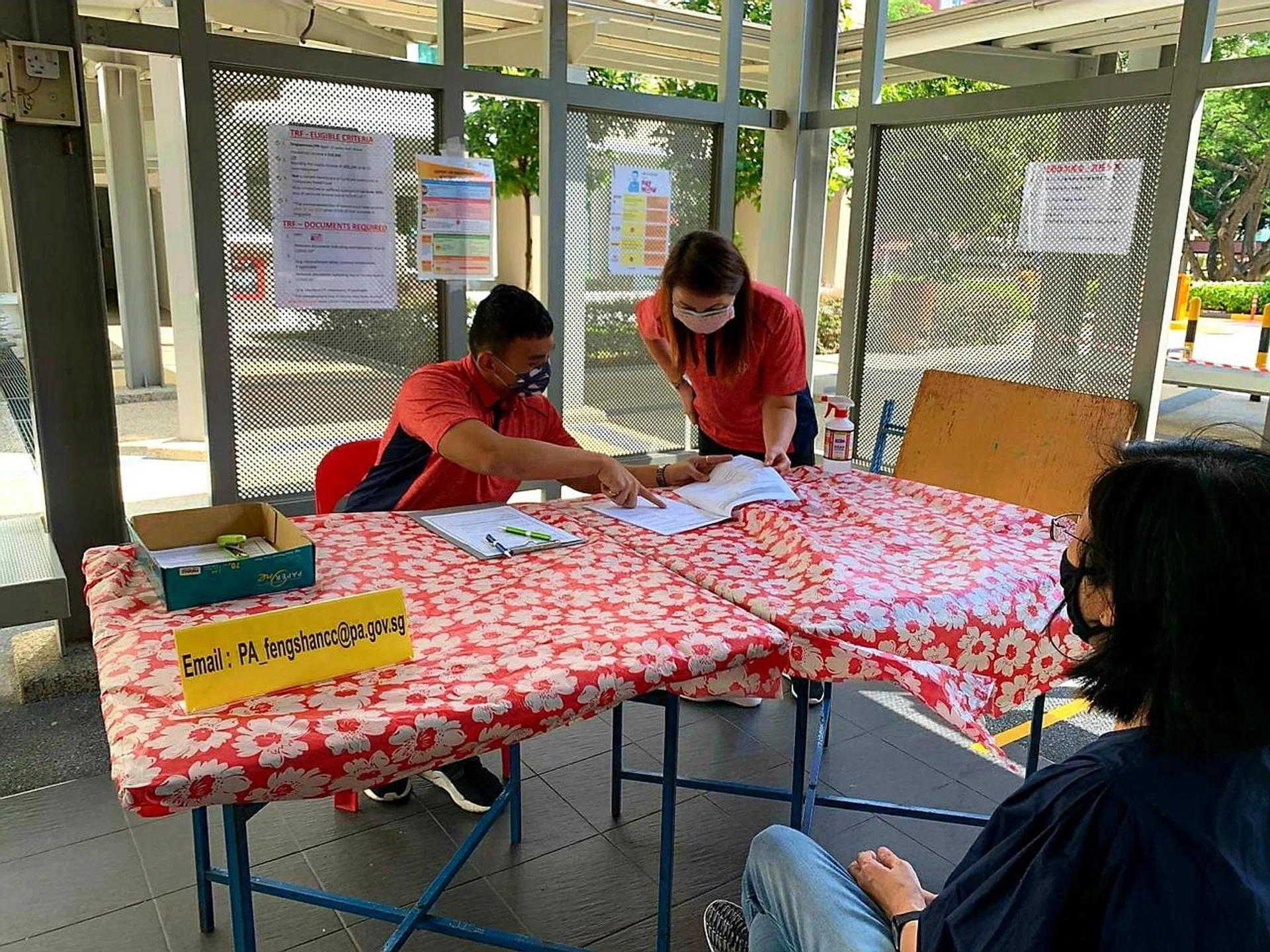 Ms Cheng Shing Meng assisting with applications for the Temporary Relief Fund. 