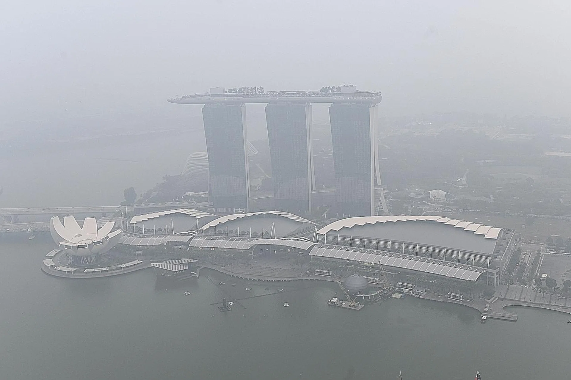 Alfresco restaurants like OverEasy in Fullerton Road, overlooking Marina Bay, have seen a drop in diners due to the haze. 