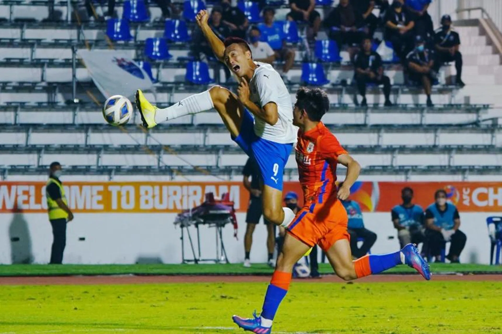 Lion City Sailors' Kim Shin-Wook in action with Shandong Taishan's Zhang Yingkai. 