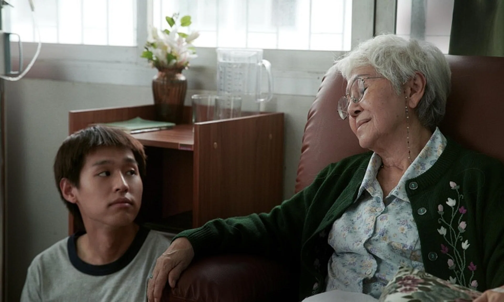 Putthipong Assaratanakul (left) as a university dropout and Usha Seamkhum as his grandmother in How To Make Millions Before Grandma Dies.