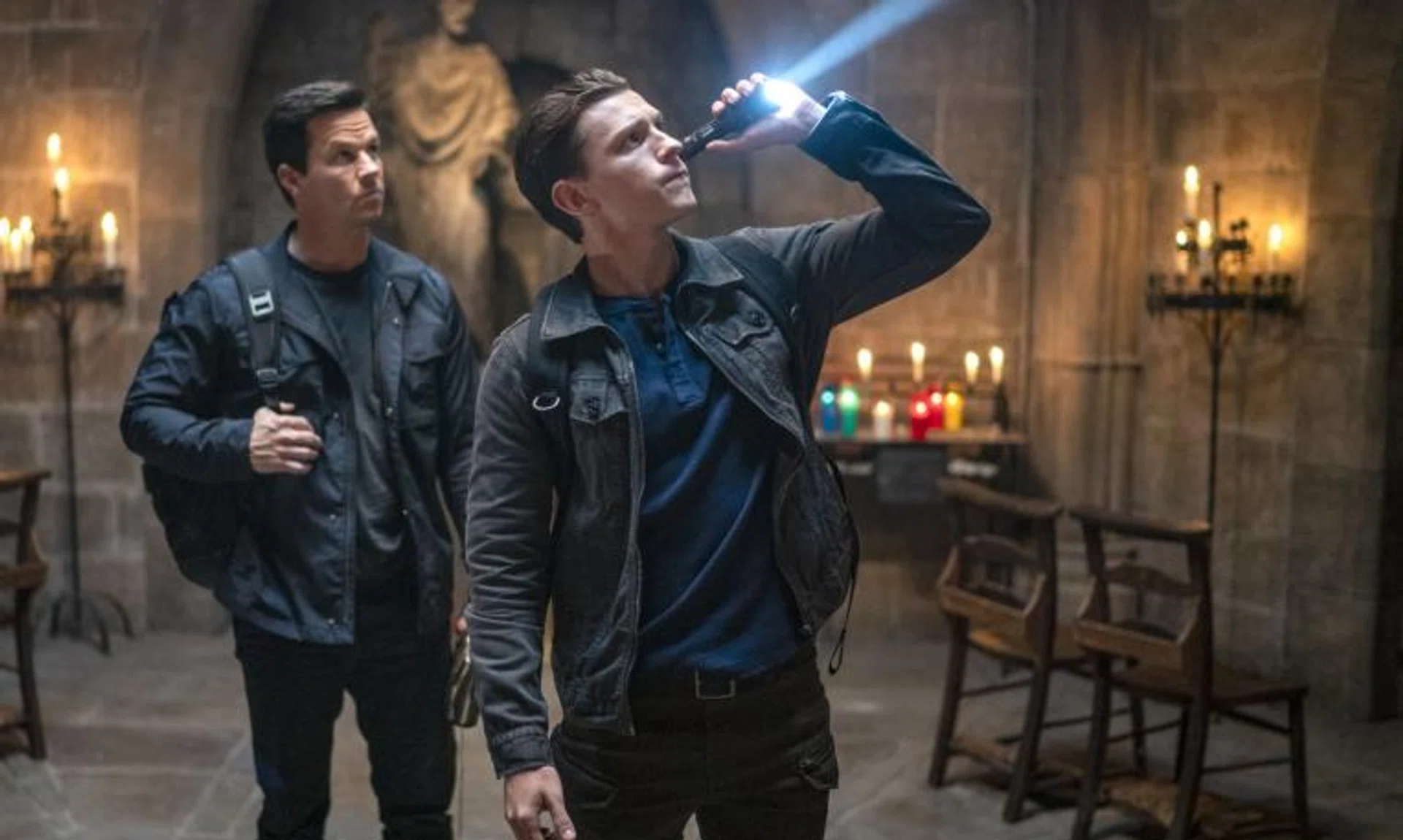 Actors Mark Wahlberg (left) and Tom Holland star in the film Uncharted.