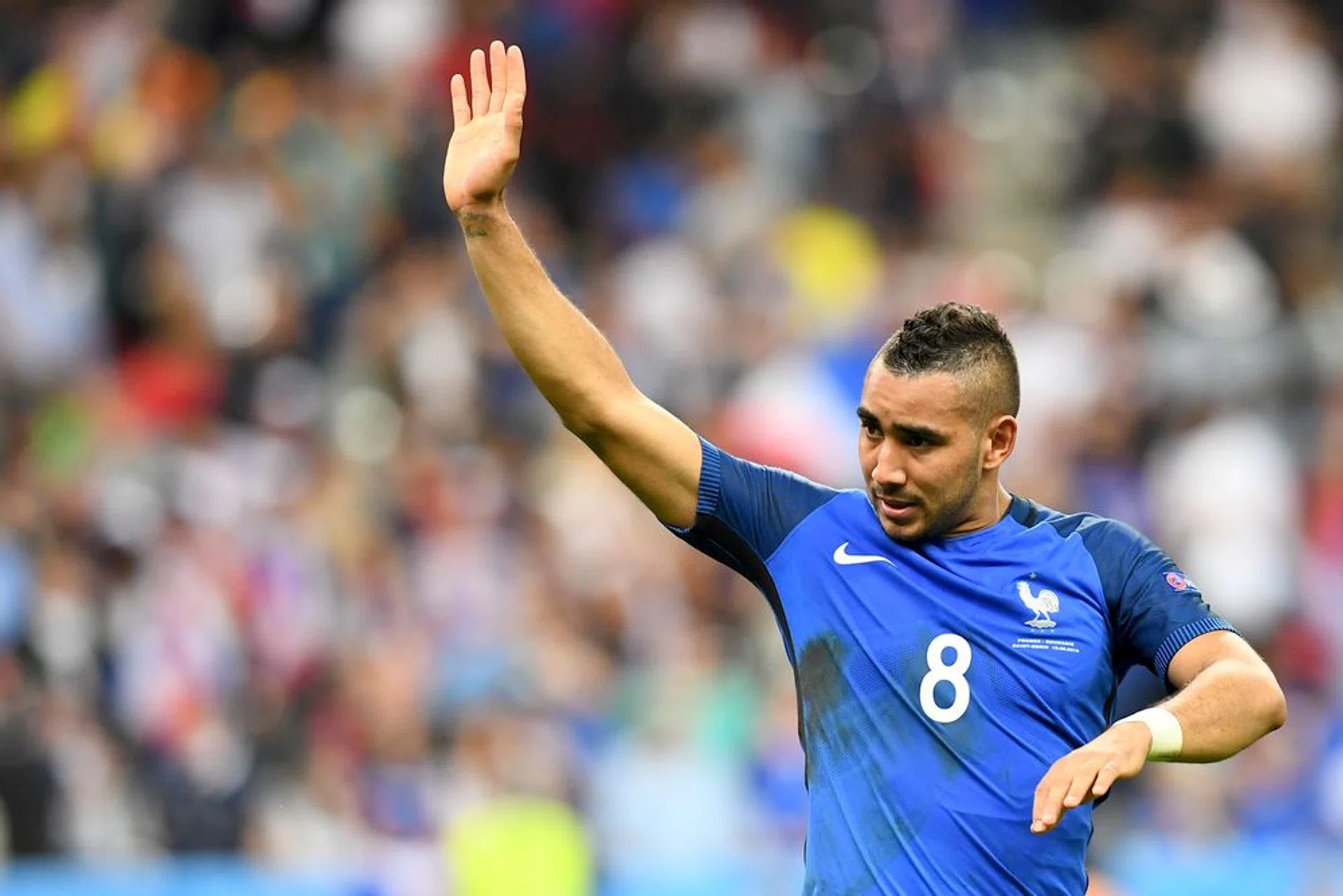 France's forward Dimitri Payet celebrates after scoring the 2-1 during the Euro 2016 group A football match between France and Romania at Stade de France.