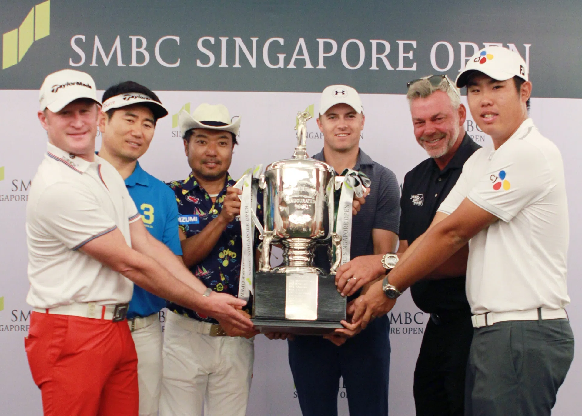 PRIZED PURSUIT: World No. 1 Jordan Spieth (fourth from far left) with other contenders (from far left) Jamie Donaldson, Yang Yong Eun, Shingo Katayama, Darren Clarke and An Byeong Hun getting a feel of the Singapore Open trophy yesterday.