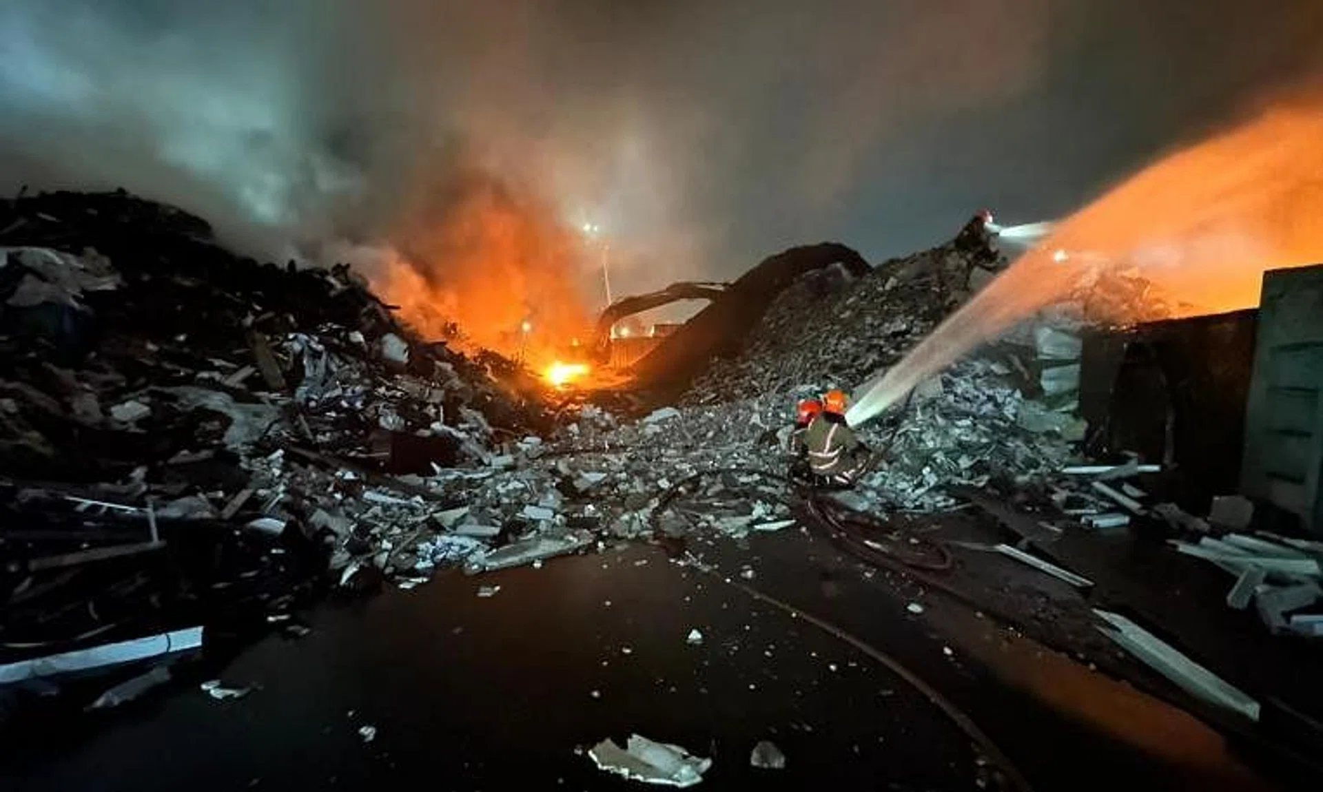 Firefighters battling a blaze at the premises of recycling and waste management company Wah and Hua on March 28, 2024.
