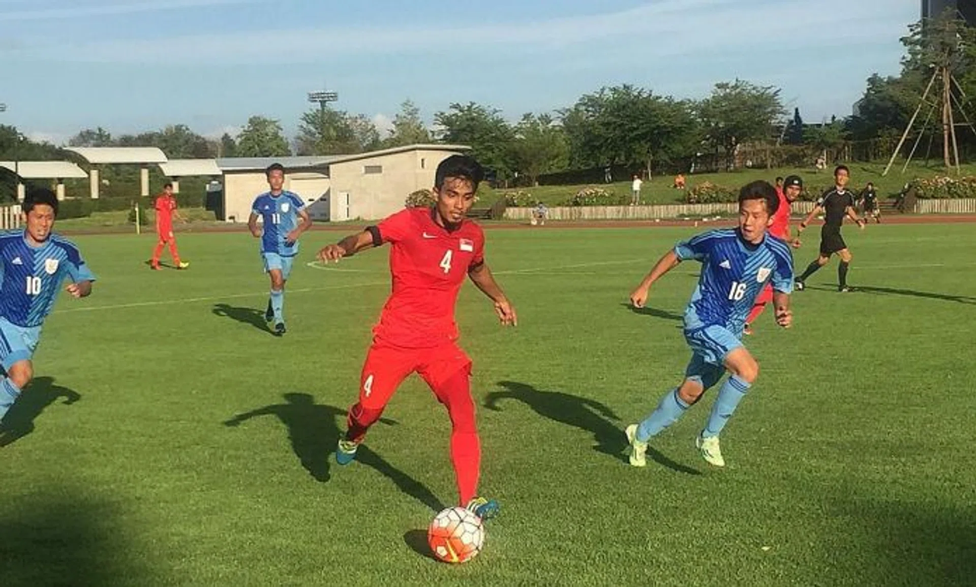 UP AGAINST IT: Yasir Hanapi  (No. 4, in red) in action against the Niigata University of Health and Welfare team yesterday.