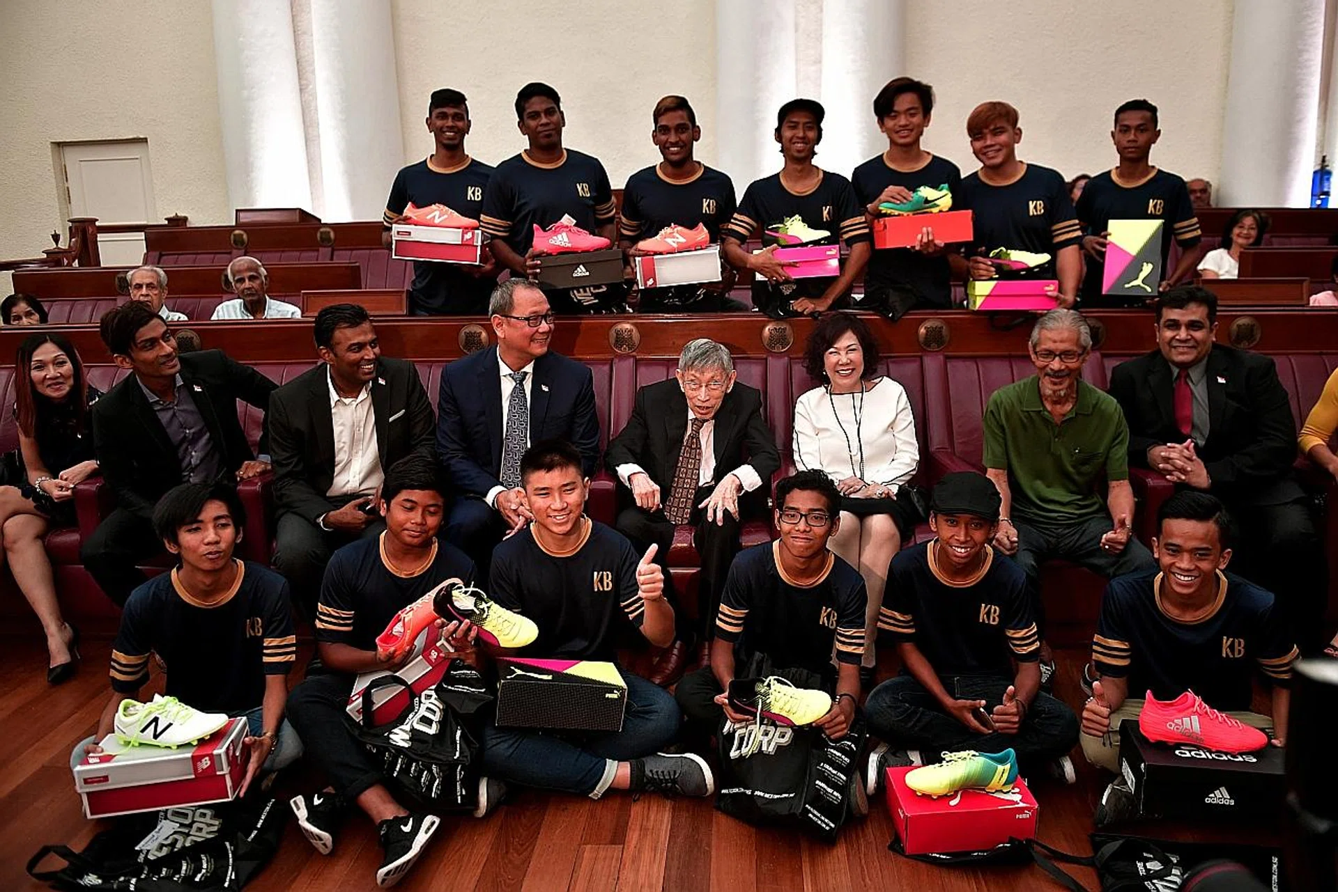 Former Potong Pasir MP Chiam See Tong (middle row, centre) with kids from the Kampong Boys team (top and bottom rows), who received football boots from the Chiam See Tong Sports Foundation yesterday. 