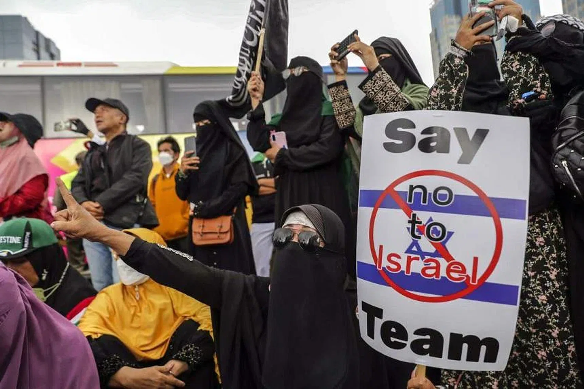 A protester shouts slogans as she holds a placard during a rally against Israel in Jakarta, on March 20, 2023. PHOTO: EPA-EFE
