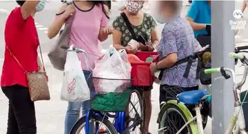 Elderly woman sells chicken from bicycle to earn extra cash