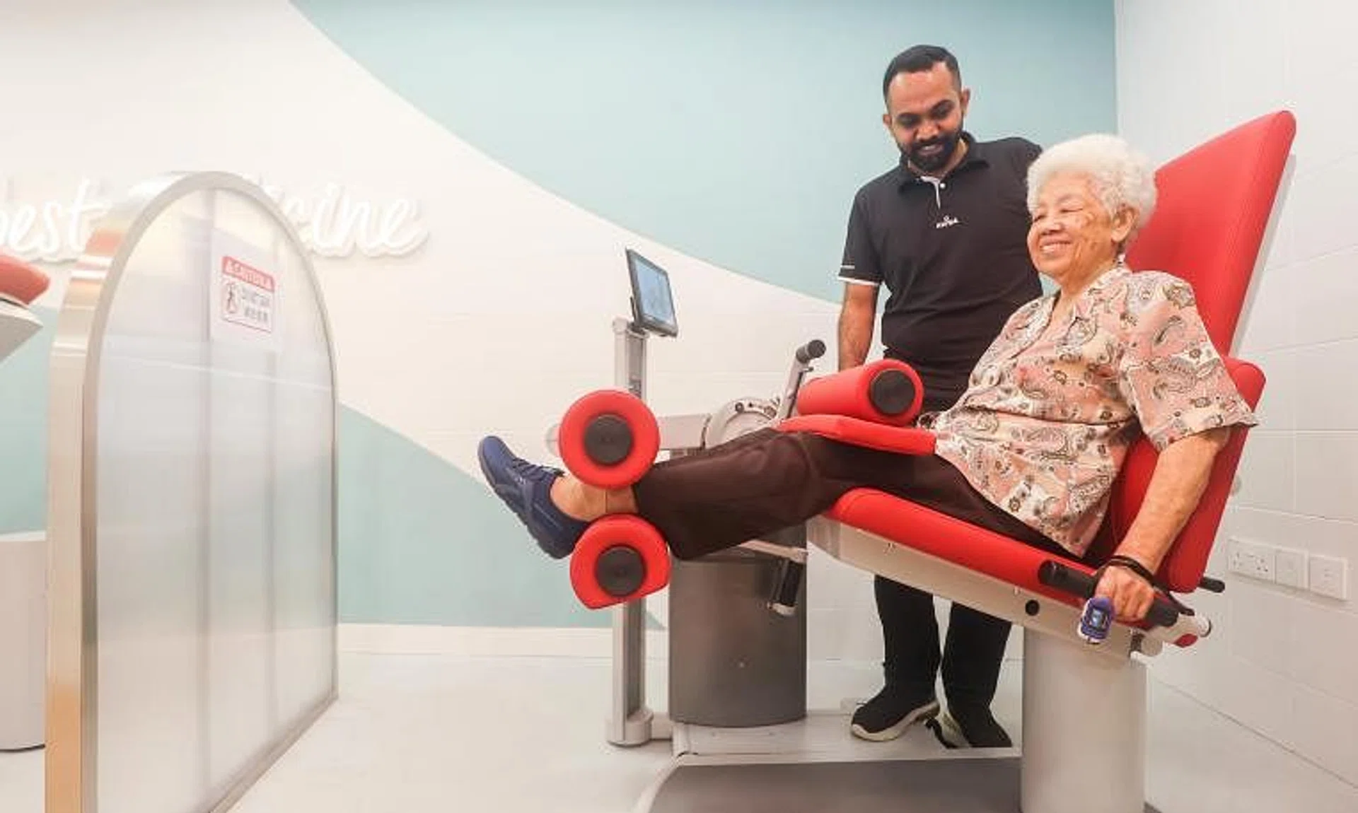 Madam Wong Siew Sin, 86, who has a heart condition, doing light exercises at a centre run by social service agency Awwa as part of a new service called Air Master.