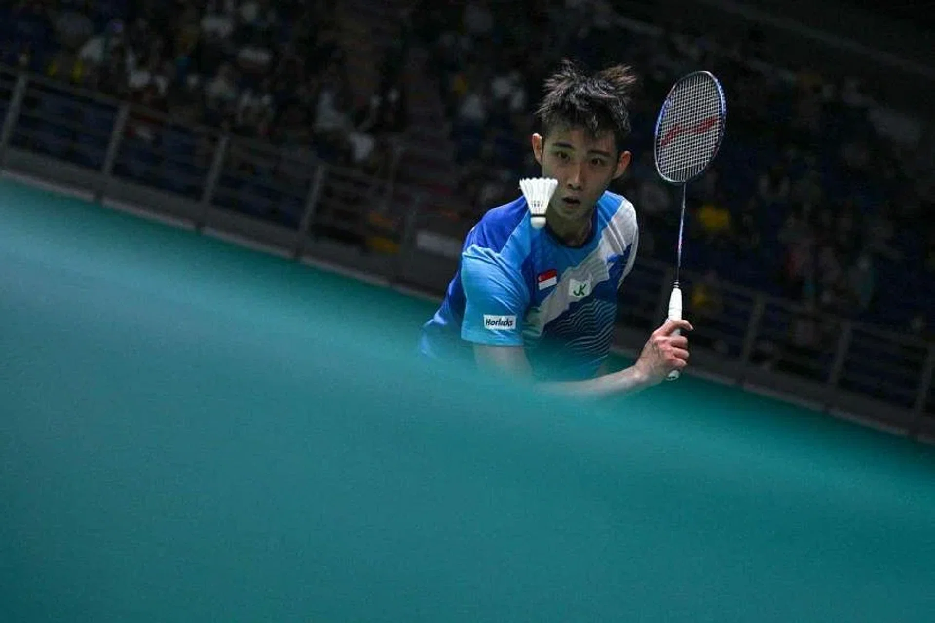 Singapore's Loh Kean Yew loses 21-16, 16-21, 21-7 to China’s world No. 13 Zhao Junpeng in the opening round of the All England Open men’s singles event. PHOTO: AFP
