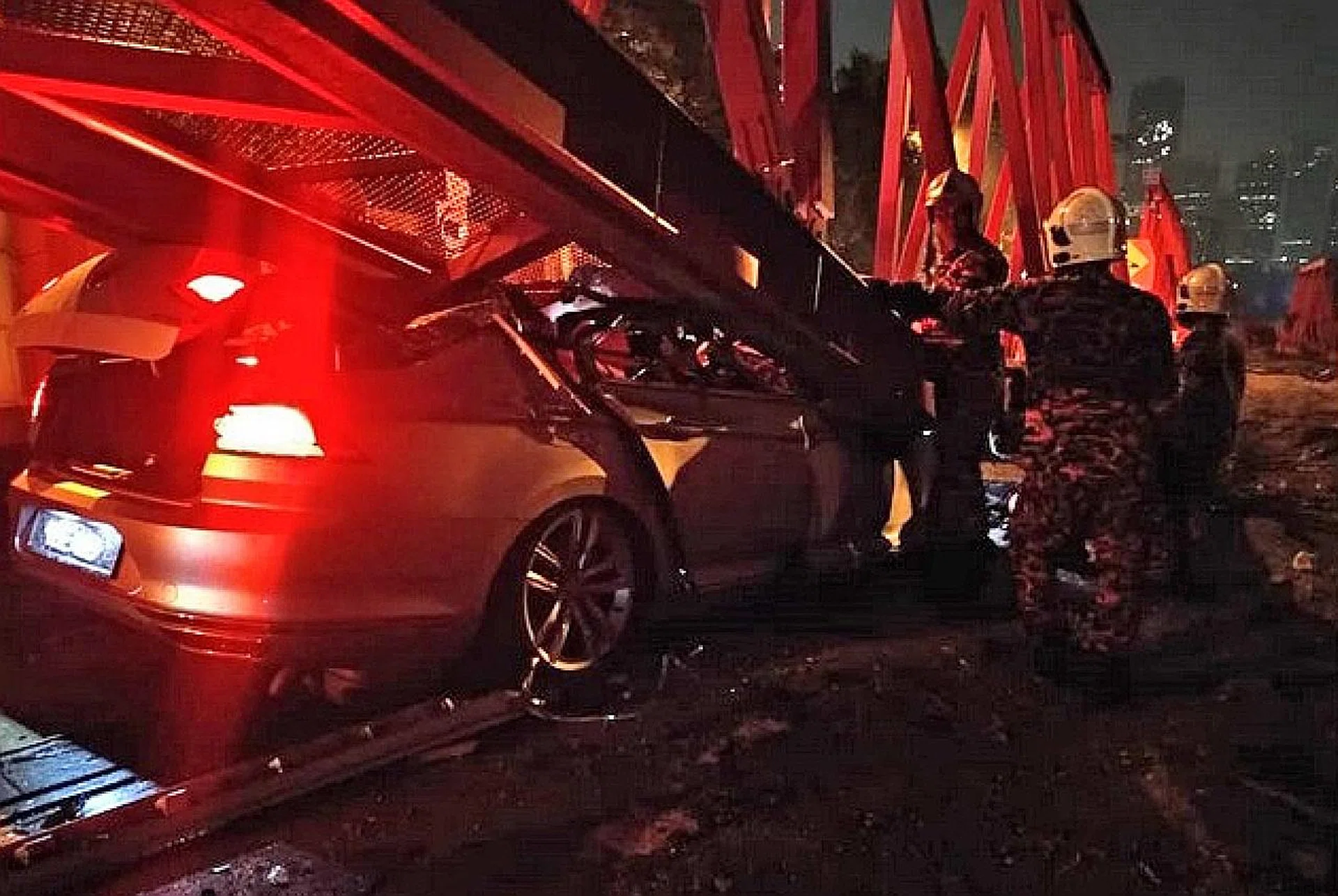 Mr Chua Zhijian's Volkswagen Passat skidded after grazing a motorcycle and crashed into a water-filled road barrier. 