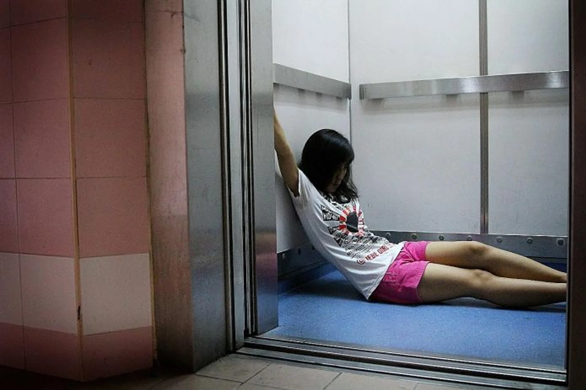 URGENT: Ms Evi Lisnawati showing how she spent the 1½ hours in the lift pressing the emergency button.