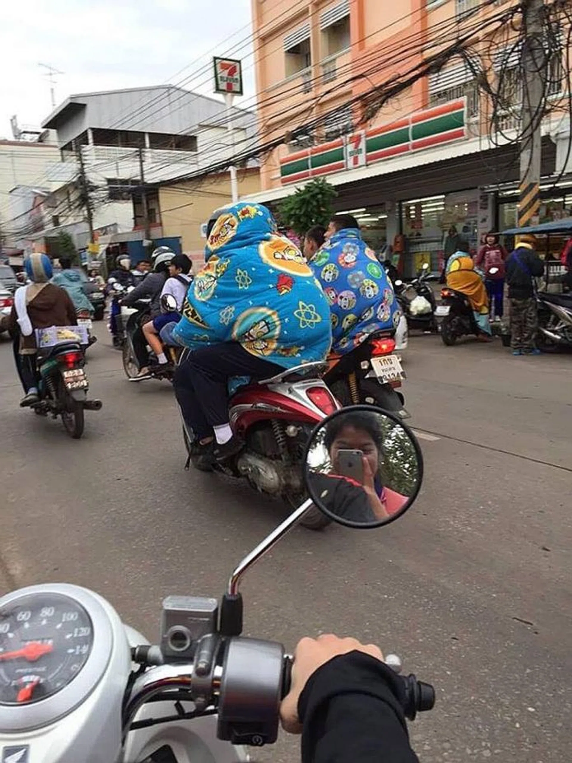 BRRR: Motorcyclists bundled up in colourful blankets while riding.