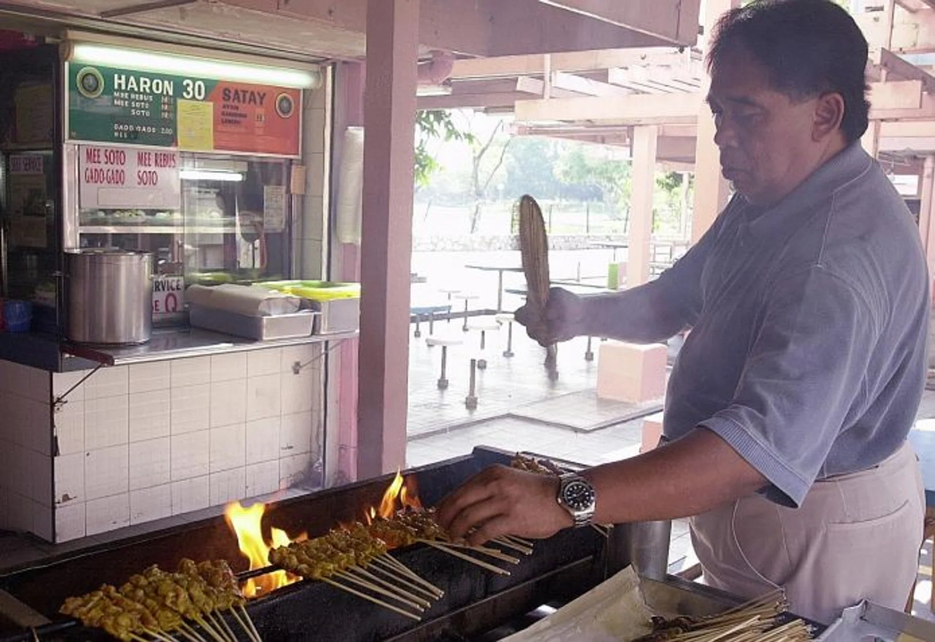 HAWKERS: (Above) Mr Haron Abu Bakar, founder of Haron Satay, has died. His daughter, Madam Harlina Haron, now runs the stall with her sister.