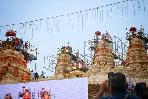 Devotees began streaming into purpose-built tents outside the temple by 7am, waiting eagerly for the main event - a Maha Kumbhabishegam (