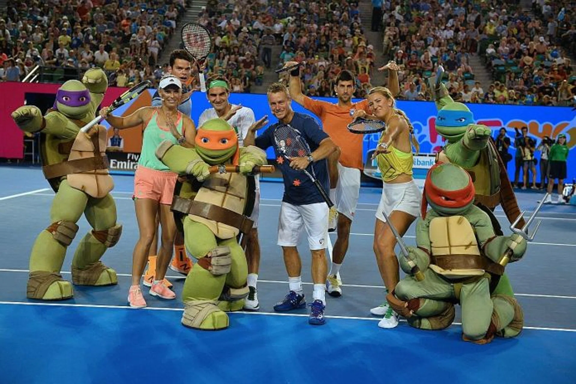 TURTLE POWER: (From left) Teenage Mutant Ninja Turtles characters posing with Caroline Wozniacki, Milos Raonic, Roger Federer, Lleyton Hewitt, Novak Djokovic and Victoria Azarenka during the Australian Open's "Kids Day" on Saturday.