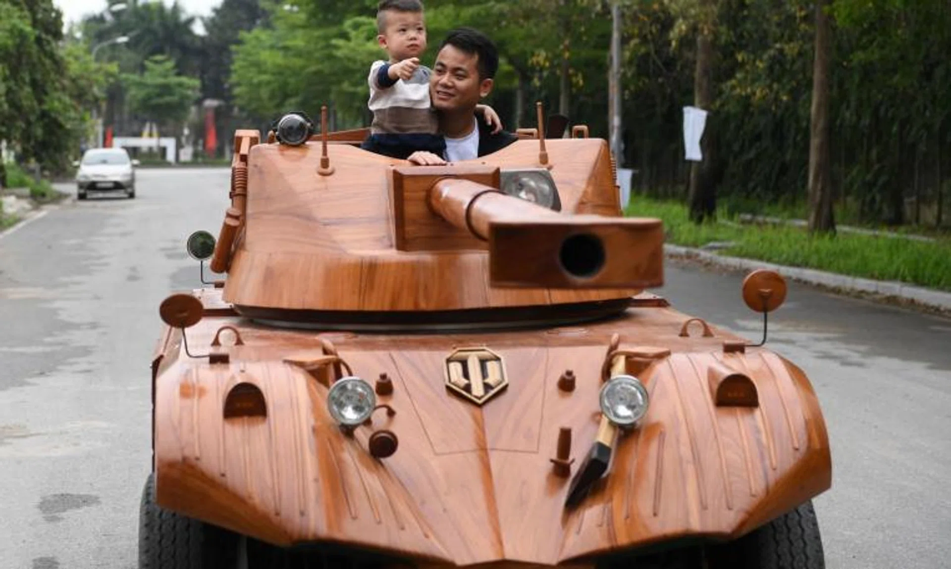 Truong Van Dao and his son in a wooden tank made from an old minibus in Bac Ninh province, Vietnam, on March 28, 2022.