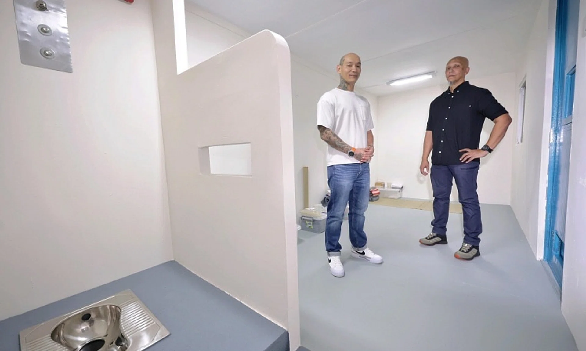 Ex-offender Andyn Kadir (left) and Mawar Community Services (MCS) programme director Mohamed Basir Mohamed Shariff at the MCS Hub's mock prison cell.