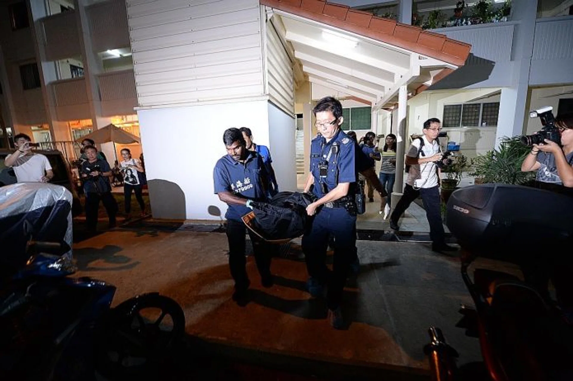 MYSTERY: Police removing his body yesterday morning. 