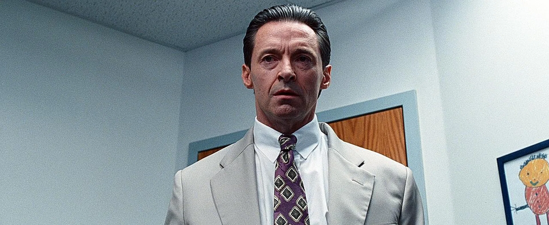(Above) Jackman as superintendent Frank Tassone who embezzled millions. 