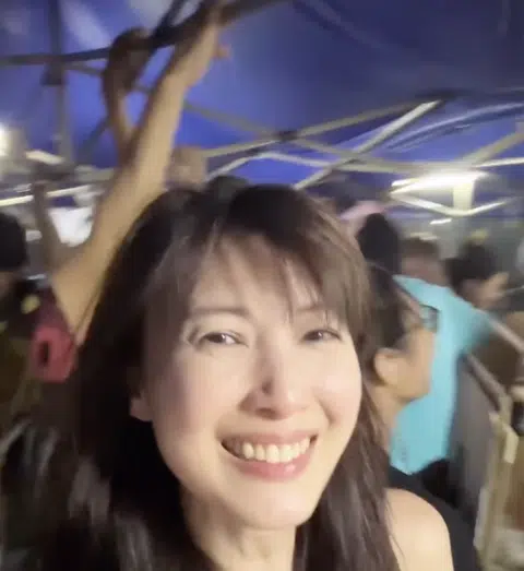 Jeanette Aw holds on to tent during Mid-Autumn Festival