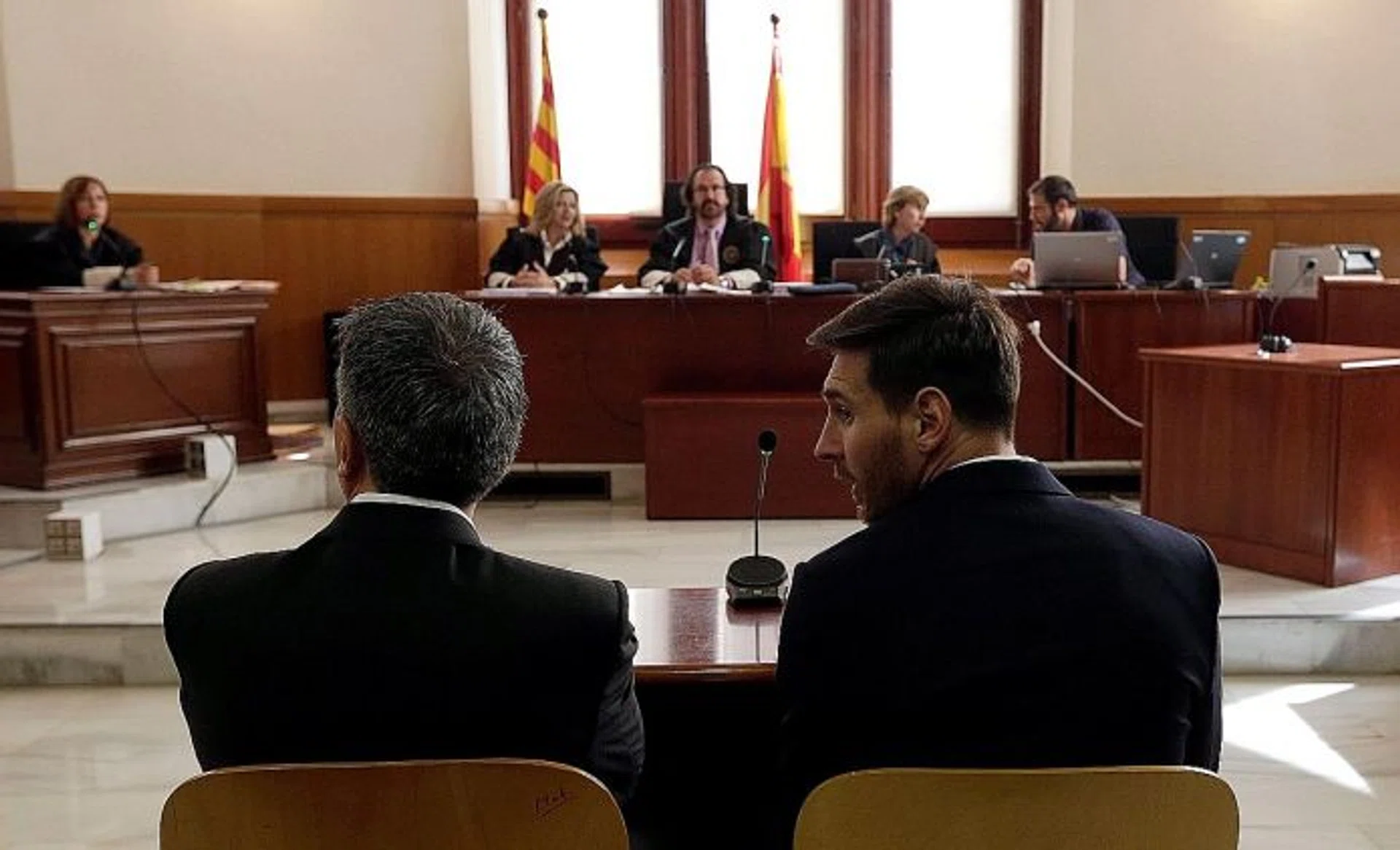 IN THE DOCK: Barcelona star Lionel Messi (above, right) and his father Jorge Horacio (above, left) face judges at a Catalan court in a tax fraud case.