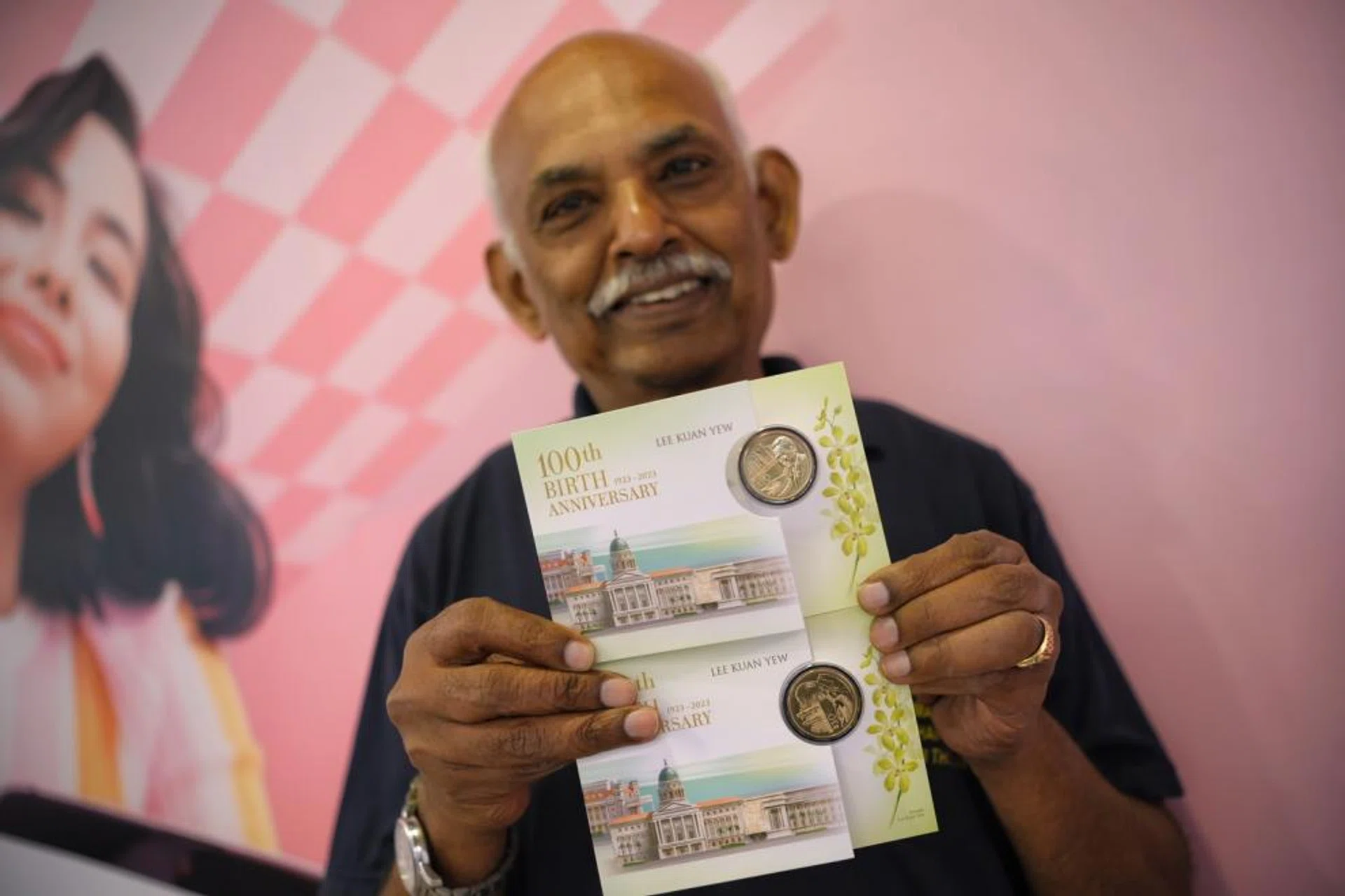Mr Andiappan with two of the eight LKY100 coins he managed to snag at the DBS Plaza Singapura branch on Dec 4. 