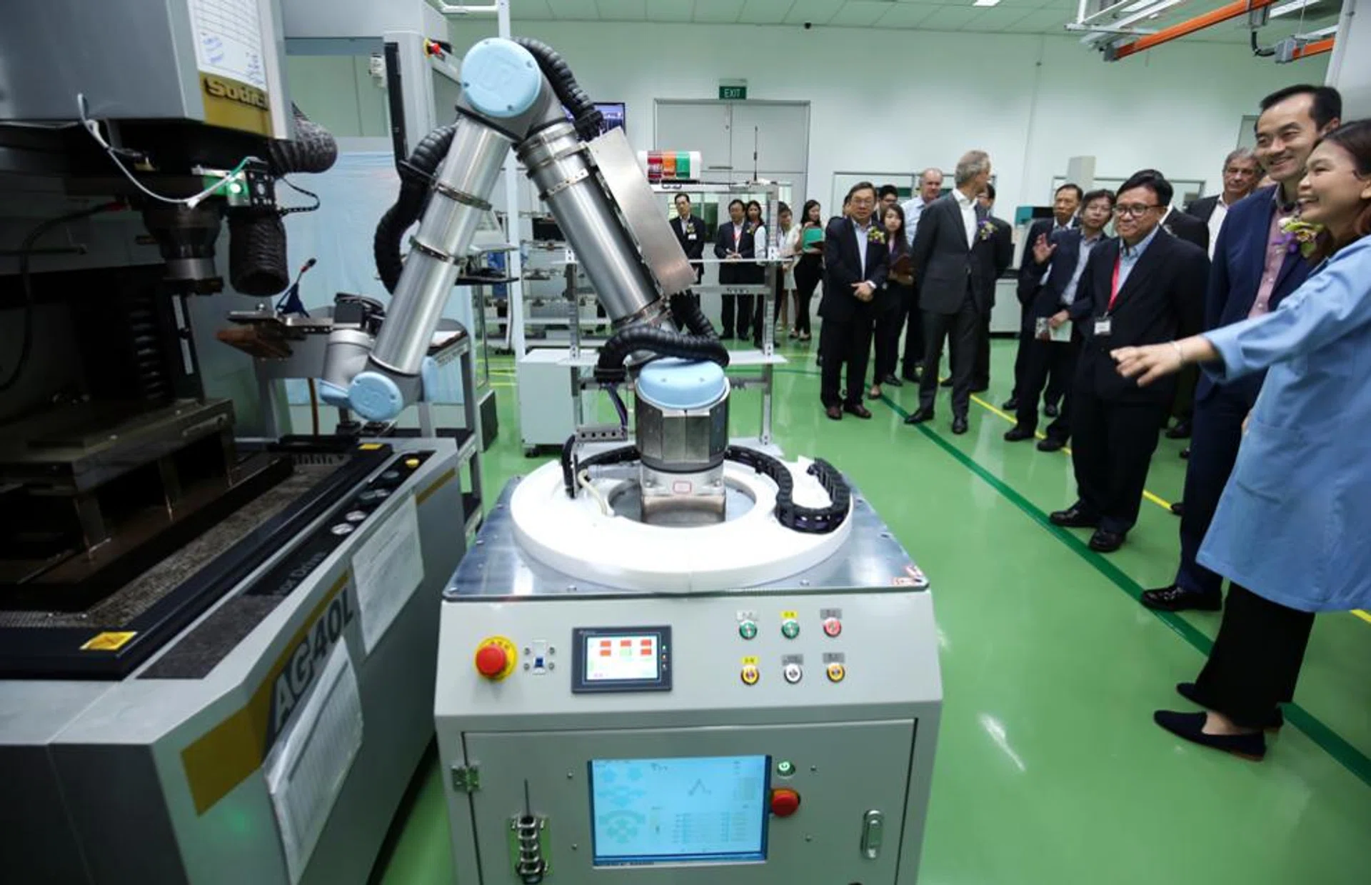 Dr Koh Poh Koon (second from right), Ministre of State for National Development, at the opening of precision engineering firm ASM Pacific Technology’s second building and new innovation centre at Yishun industrial park.