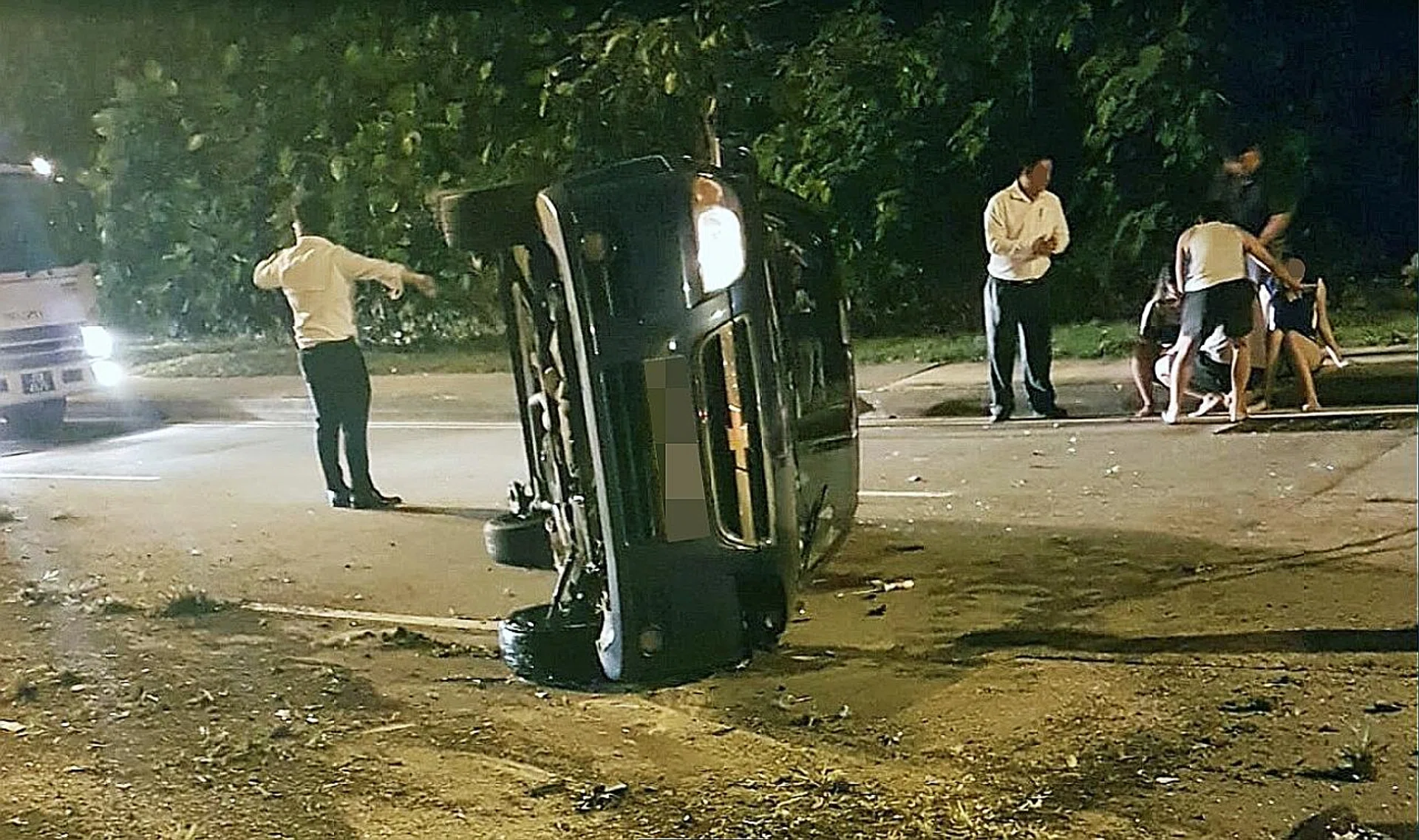 Onlookers comforting the women at the side of the road. 