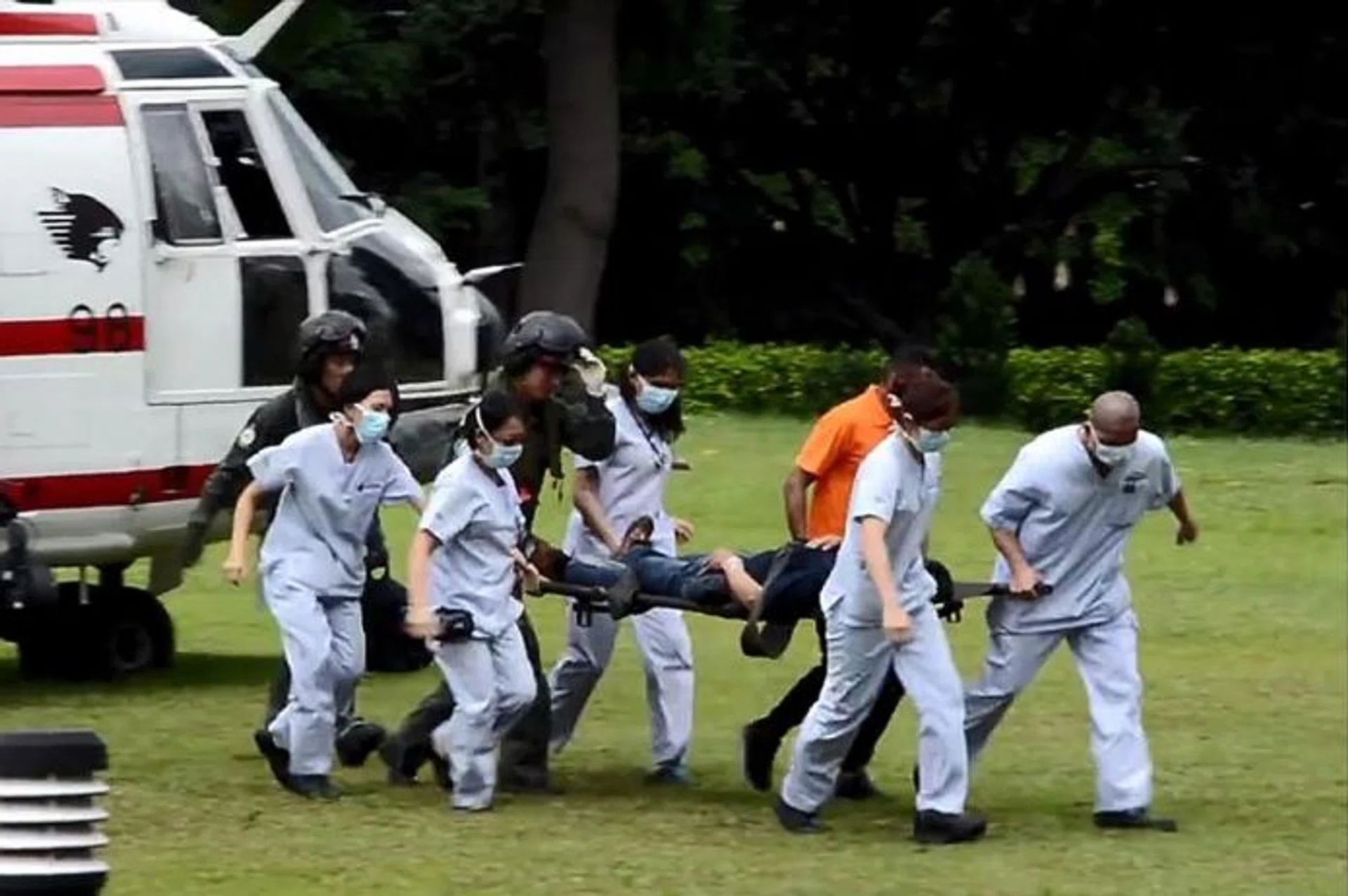 'LIKE CLOCKWORK': The patient being transferred from the rescue helicopter to an ambulance which rushed him to Singapore General Hospital.