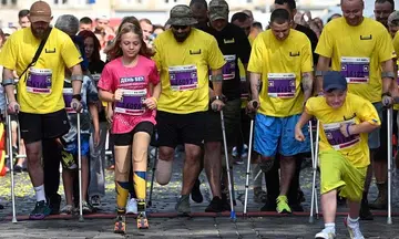 Girl, 12, who lost legs in Russian missile attack, runs at Ukraine city half-marathon