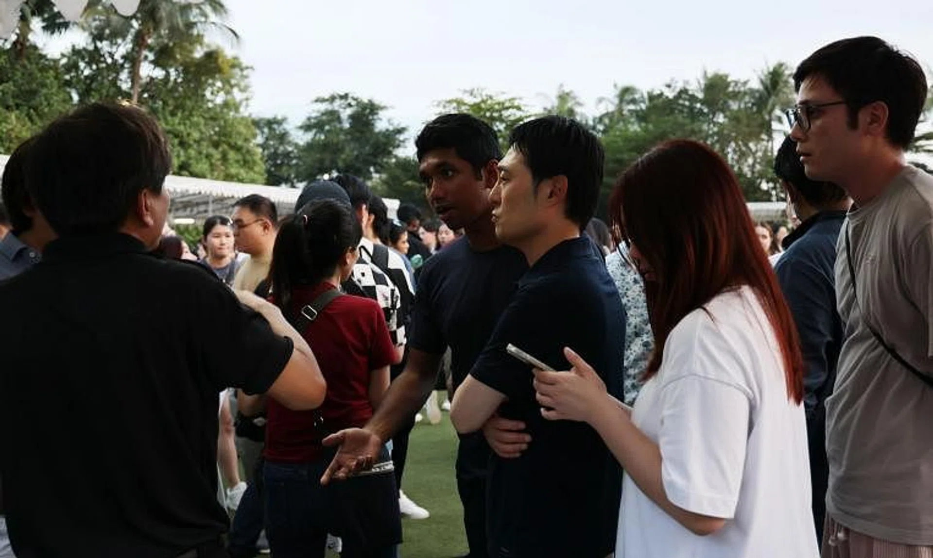 Attendees speaking with event staff at the Sky Lantern Festival at Sentosa on Feb 21.